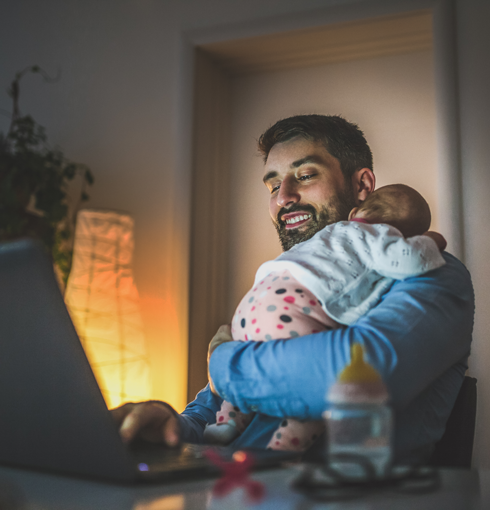 man-holding-baby-with-laptop man-holding-baby-with-laptop